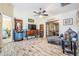 Cozy living room with wood-look flooring, ceiling fan, and view into other rooms at 29307 Schinnecock Hills Ln, San Antonio, FL 33576