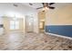 Bright living room featuring wood-look floors, fresh paint, and modern ceiling fan at 29307 Schinnecock Hills Ln, San Antonio, FL 33576