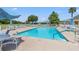 Outdoor pool featuring clear blue water, lounge chairs, and ample seating, perfect for relaxation and recreation at 29307 Schinnecock Hills Ln, San Antonio, FL 33576