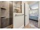 Modern walk-in shower with tiled walls, a built-in shelf, and a glass partition at 29307 Schinnecock Hills Ln, San Antonio, FL 33576