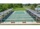 Aerial view of shuffleboard courts and benches, with a golf course and pool in the background at 29307 Schinnecock Hills Ln, San Antonio, FL 33576