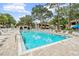 A sparkling community pool offers a refreshing escape with plenty of lounge chairs and shade at 2983 Bonaventure Cir # 204, Palm Harbor, FL 34684