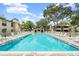 A sparkling community pool offers a refreshing escape with plenty of lounge chairs and shade at 2983 Bonaventure Cir # 204, Palm Harbor, FL 34684