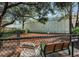 A fenced community dog park featuring a bench and open space for dogs to play and socialize at 2983 Bonaventure Cir # 204, Palm Harbor, FL 34684