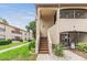 Welcoming exterior showcasing a two-story home, neat landscaping, and a screened in porch for outdoor enjoyment at 2983 Bonaventure Cir # 204, Palm Harbor, FL 34684