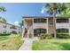 Welcoming condo building with lush landscaping and visible unit numbers at 2983 Bonaventure Cir # 204, Palm Harbor, FL 34684