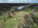 Gorgeous aerial view of golf course featuring sand traps, mature trees and tranquil water features at 3822 Salida Delsol Dr, Sun City Center, FL 33573