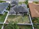 Aerial view of backyard with white vinyl fence, patio with seating, and well-maintained lawn at 3822 Salida Delsol Dr, Sun City Center, FL 33573