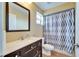 Bathroom features a wood vanity with a modern countertop, neutral wall color, and a shower with an updated curtain at 3822 Salida Delsol Dr, Sun City Center, FL 33573