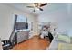 Bedroom with hardwood floors, ceiling fan, and organized storage shelves at 3822 Salida Delsol Dr, Sun City Center, FL 33573