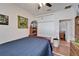 Bedroom featuring a bed, closet, door to another room, and display shelving with fun decor at 3822 Salida Delsol Dr, Sun City Center, FL 33573