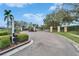 View of Villa d'Este's community entrance, featuring well-maintained landscaping at 3822 Salida Delsol Dr, Sun City Center, FL 33573