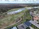 Aerial view of the community golf course with pond and lush landscaping at 3822 Salida Delsol Dr, Sun City Center, FL 33573