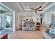 Spacious living room featuring an open concept, tile flooring, and a ceiling fan at 3822 Salida Delsol Dr, Sun City Center, FL 33573