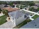 Aerial view of rear of home with grey roof, a concrete driveway and partial white fence at 3822 Salida Delsol Dr, Sun City Center, FL 33573