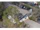 Drone view showcasing the roof, backyard and surrounding trees of the property at 3942 La Costa Ln, Largo, FL 33771