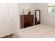 Bedroom features a dresser with storage drawers and a mirror with a bright window at 3942 La Costa Ln, Largo, FL 33771