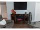 Living room features a fireplace, media console, and glass coffee table creating a modern space at 3942 La Costa Ln, Largo, FL 33771