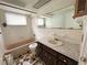 Bathroom with retro tile and finishes, featuring a single sink vanity and tub/shower combination at 4233 Abaco Ct, New Port Richey, FL 34653