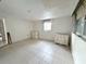 Bright bedroom featuring tile floors, neutral walls, two dressers, and a window for natural light at 4233 Abaco Ct, New Port Richey, FL 34653