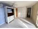 Bedroom with white wood-look flooring, closet, dresser and bi-fold doors to adjacent closet at 4233 Abaco Ct, New Port Richey, FL 34653