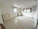 Spacious bedroom with tile flooring, neutral paint, and natural lighting from two windows at 4233 Abaco Ct, New Port Richey, FL 34653