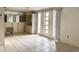 Dining room with tile flooring, mirrored wall, large windows, and a built-in cabinet for storage and display at 4233 Abaco Ct, New Port Richey, FL 34653