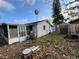 Back exterior of home showing patio, yard and storage shed at 4233 Abaco Ct, New Port Richey, FL 34653