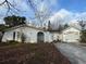 Exterior of a single-story home featuring a driveway and arched entrance at 4233 Abaco Ct, New Port Richey, FL 34653