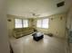 Cozy living room with laminate floors, bright windows, overhead fan, perfect for relaxation and casual living at 4233 Abaco Ct, New Port Richey, FL 34653