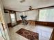 Enclosed sunroom with ceiling fan, tile floors, and sliding glass door to the outside at 4233 Abaco Ct, New Port Richey, FL 34653