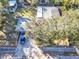 Aerial view of a charming home featuring a spacious yard, mature trees, and a serene neighborhood setting at 472 Pine St, Tarpon Springs, FL 34689