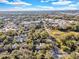 Overhead view of property with a view of the surrounding community with ample tree coverage at 472 Pine St, Tarpon Springs, FL 34689