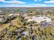 High definition view of neighborhood with ample tree coverage and a pond close by at 472 Pine St, Tarpon Springs, FL 34689