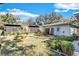 A lovely shot of the backyard showing a well manicured lawn, plants, fence and blue sky at 472 Pine St, Tarpon Springs, FL 34689