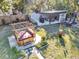 Aerial view of backyard featuring a hot tub, covered dining area, and well-maintained lawn at 472 Pine St, Tarpon Springs, FL 34689