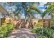 Fenced backyard adorned with tropical landscaping, providing a private and serene outdoor space at 472 Pine St, Tarpon Springs, FL 34689