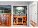 Bar area with a mini-fridge and shelving beside living room at 472 Pine St, Tarpon Springs, FL 34689