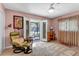 Comfortable bedroom featuring a chair and screened porch access at 472 Pine St, Tarpon Springs, FL 34689