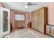 Bedroom with a Murphy bed, complemented by neutral carpeting and curtains at 472 Pine St, Tarpon Springs, FL 34689