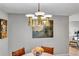 Dining area with a mid-century modern chandelier and a decorative painting on a gray wall at 472 Pine St, Tarpon Springs, FL 34689