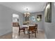 Bright dining room with terrazzo floors, a modern light fixture and seating for four at 472 Pine St, Tarpon Springs, FL 34689