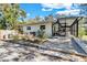 Rear view of the home highlighting the screened patio, providing an inviting space for outdoor enjoyment at 472 Pine St, Tarpon Springs, FL 34689