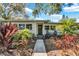 Charming single-story home with a landscaped front yard and inviting entryway at 472 Pine St, Tarpon Springs, FL 34689