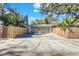 A two car garage provides ample parking space, complete with fencing on both sides at 472 Pine St, Tarpon Springs, FL 34689