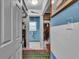 Hallway view leading to the blue-tiled bathroom, showcasing charming architectural details at 472 Pine St, Tarpon Springs, FL 34689