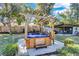 Relax in this backyard hot tub with a wooden pergola, creating a private and tranquil oasis at 472 Pine St, Tarpon Springs, FL 34689