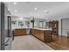 Open kitchen layout with stainless steel appliances, an island, and hardwood floors at 472 Pine St, Tarpon Springs, FL 34689