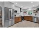 Modern kitchen with stainless steel appliances, and white and wood cabinets at 472 Pine St, Tarpon Springs, FL 34689