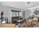 Bright living room with terrazzo floors, large windows, and neutral decor at 472 Pine St, Tarpon Springs, FL 34689